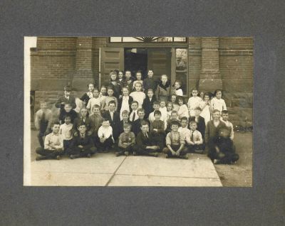 Unidentified

This was Donated by Anne McManus

Unidentified photo mounted on board of a classroom posing outside the school door. 



